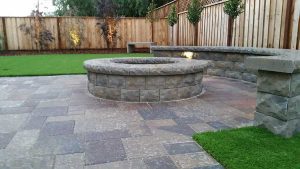 Paver stones outdoor fireplace step wall seating patio