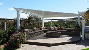 Paver stones outdoor fireplace step wall seating patio pergola