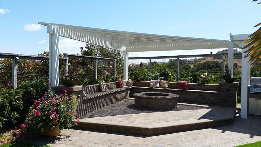 Paver stones outdoor fireplace step wall seating patio pergola