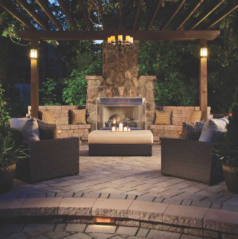 Paver stones outdoor fireplace step wall seating patio pergola