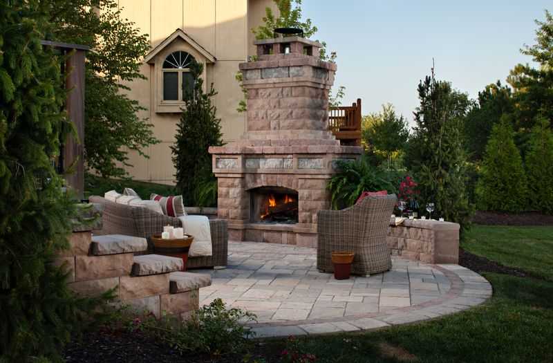 Paver stones outdoor fireplace step wall seating patio