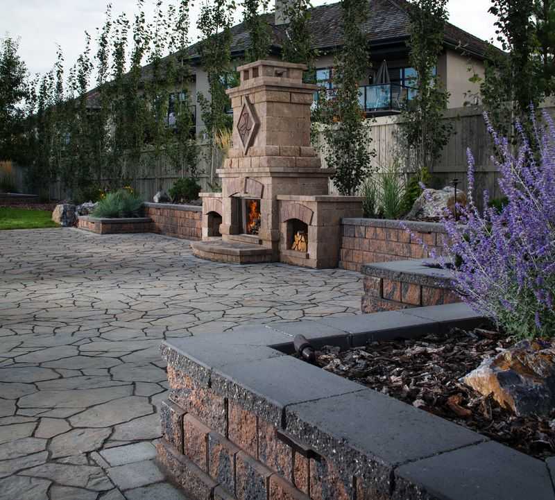 Paver stones outdoor fireplace step wall seating patio
