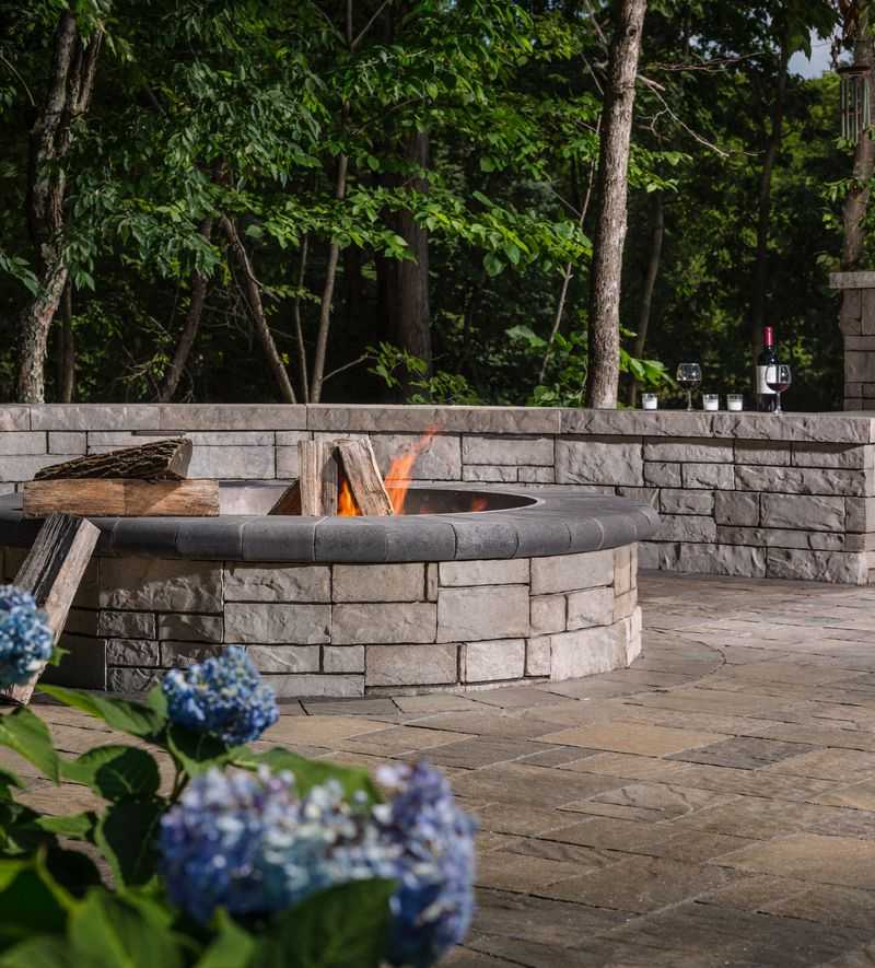 Paver stones outdoor fireplace step wall seating patio