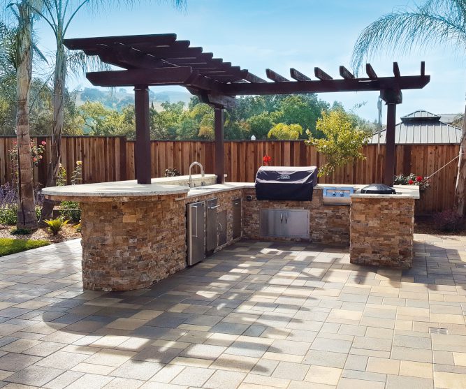 A custom paverstone driveway leading up to a house