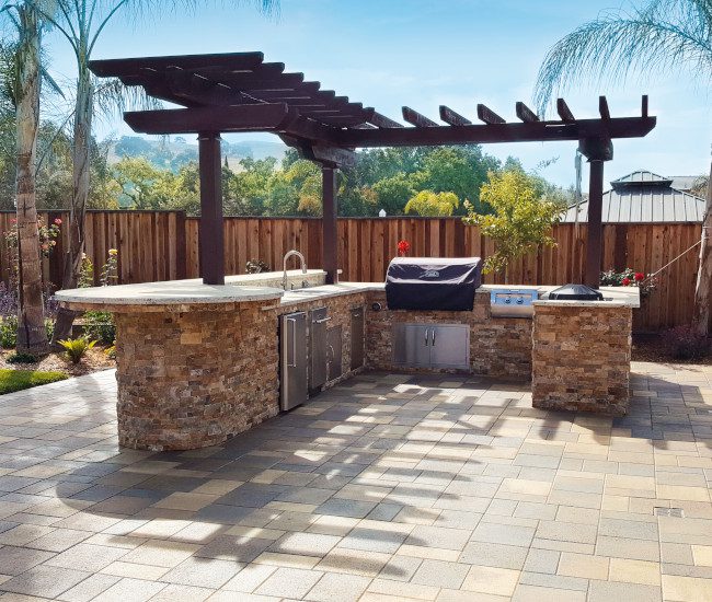 An elegant outdoor kitchen made with paver stones