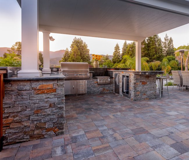 An elegant outdoor kitchen made with paver stones