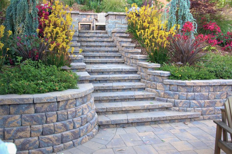 A full paver stone staircase – there are many different ways to incorporate walls & steps into your new backyard.