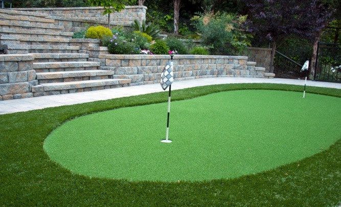 A custom paverstone driveway leading up to a house
