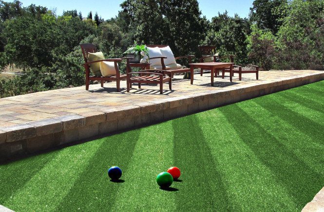 A custom paverstone driveway leading up to a house