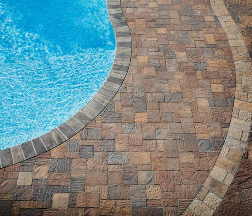 A vibrant paver stone pool deck increases this properties value and offers higher durability than other materials